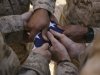 stk102498m_marines-fold-an-american-flag-after-it-was-raised-in-memory-of-a-fallen-soldier-poste.jpg