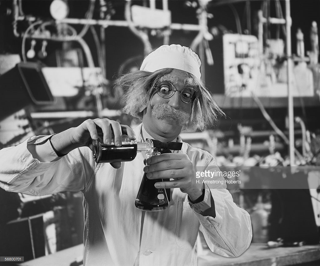mad-scientist-in-laboratory-mixing-chemicals-picture-id56800701